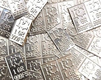 May include: A pile of silver bullion bars with the inscription "1 GR 999FS" on each bar.