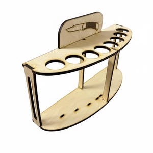Op de afbeelding: Een houten messenhouder met een gebogen ontwerp. De houder heeft meerdere ronde openingen voor messen en een kleine, rechthoekige achterwand met een mes-silhouet. De natuurlijke houtkleur geeft het een rustieke uitstraling.
