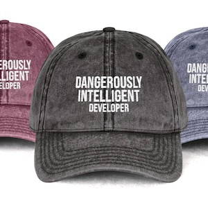 May include: A set of three ceramic mugs with a speckled, cream-colored glaze. Each mug features a different hand-painted floral design in shades of blue, green, and yellow. The mugs have a simple, rounded shape and a comfortable handle.