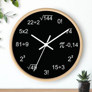 May include: A round wall clock with a black face and a light wood-colored frame. The clock face features white numbers and mathematical symbols. The clock hands are white.