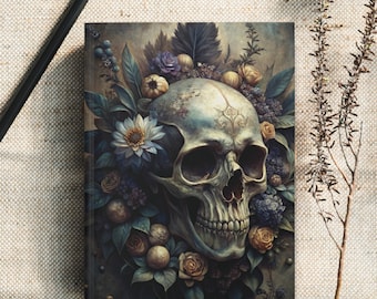 May include: A journal with a skull and floral design. The cover features a detailed illustration of a human skull surrounded by flowers in shades of blue, yellow, and green. The journal is rectangular and appears to be hardcover.