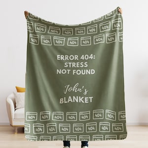 May include: A green fleece blanket with a white pattern of 404 error icons. The blanket has the text "ERROR 404: STRESS NOT FOUND" and "John's BLANKET" in white text.