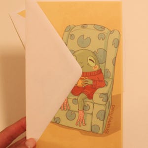 Tarjeta de felicitación en blanco/impresión con una rana acogedora