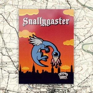 May include: A blue and pink enamel pin featuring a cartoon creature with a long neck and a single eye, with the text "Snallygaster" above it and "CRYPTO 200EEZ" below it.