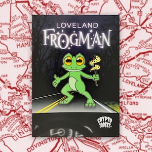 May include: A green frog wearing a yellow hat with a lightning bolt design, holding a wand with a yellow star on top. The frog is standing on a road with yellow lines. The text "LOVELAND FROGMAN" is above the frog. The text "CRYPTO 200EEZ" is below the frog.