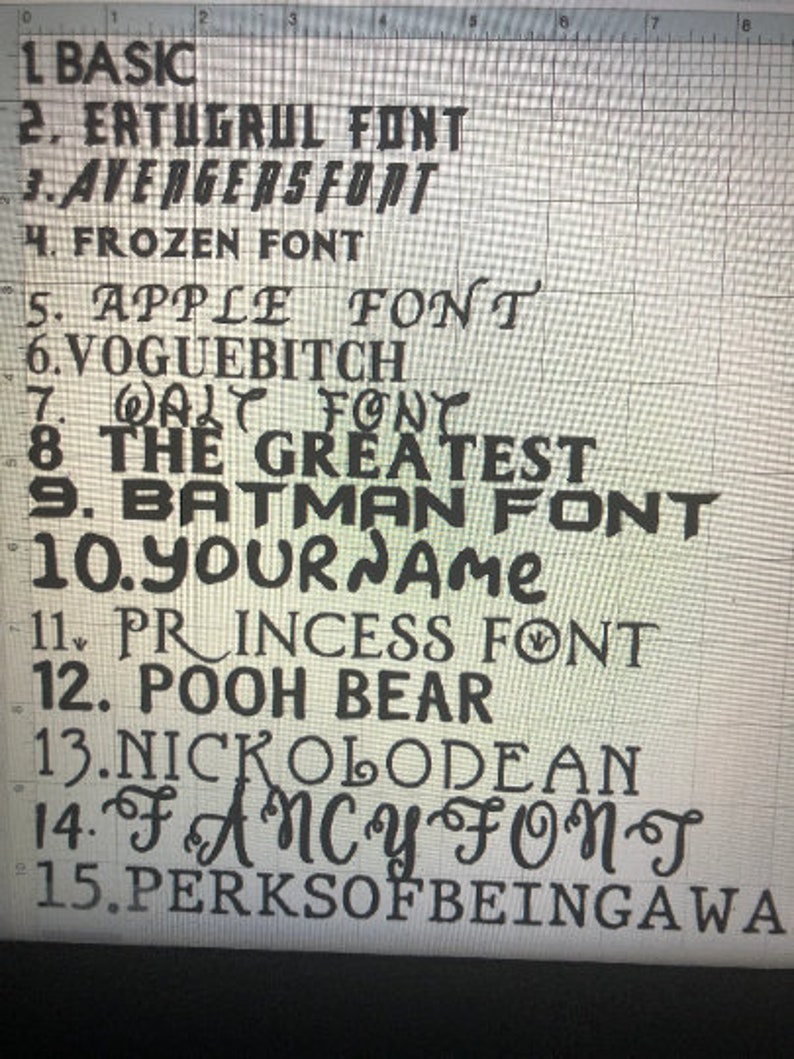 May include: A close-up of a white gridded surface with a list of 15 different font names written in black. The font names include "Basic", "Ertugrul Font", "Avengers Font", "Frozen Font", "Apple Font", "Voguebitch", "Walt Font", "The Greatest", "Batman Font", "Your Name", "Princess Font", "Pooh Bear", "Nickelodeon", "Fancy Font", and "Perks of Being a Wa".