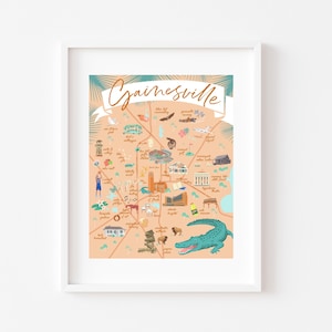 May include: A colorful illustrated map of Gainesville, Florida, with a banner at the top that says "Gainesville". The map features landmarks and points of interest, including the University of Florida, the Hippodrome Theatre, and the Gainesville Raceway. There is also an alligator in the bottom right corner.
