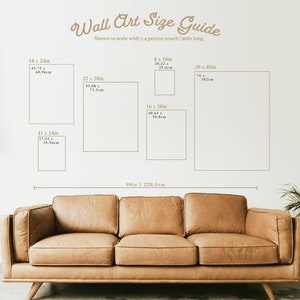 May include: A guide to wall art sizes, shown to scale with a 90-inch long couch. The guide shows different sizes of wall art, ranging from 11 x 14 inches to 30 x 40 inches, with corresponding measurements in centimeters.