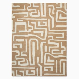 May include: A beige and white area rug with a geometric pattern of interlocking lines and shapes.