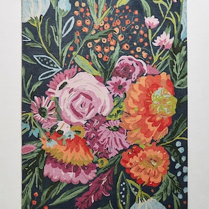 Puede incluir: Una alfombra azul marino con un patr&oacute;n floral con flores rosas, naranjas y verdes. La alfombra tiene un aspecto y una sensaci&oacute;n de tejido a mano.