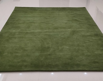 May include: A solid green rug with a smooth, plush texture. The rug is rectangular and has a subtle sheen.