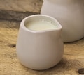 Pack of 12 commercial 1.5oz white ceramic mini milk jugs for serving milk, custard, cream etc