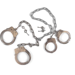 Heavy hand and leg irons with connecting chain