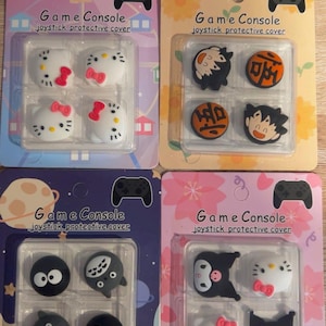 Peut inclure: Quatre paquets de protections de joystick pour consoles de jeux. Chaque paquet présente un design différent, comprenant des personnages de dessins animés et des symboles. Le texte "Game Console joystick protective cover" est imprimé sur chaque paquet.