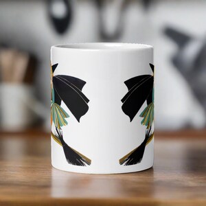 This ceramic coffee mug features a vintage deco illustration of a cute flapper witch flying on a broom with an orange full moon behind her.
