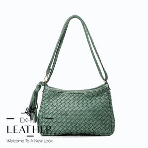 May include: A woven green leather shoulder bag with a long strap and a tassel. The bag has a rectangular shape with a curved top. The text "EXHIBIT LEATHER" and "Welcome To A New Look" are visible.
