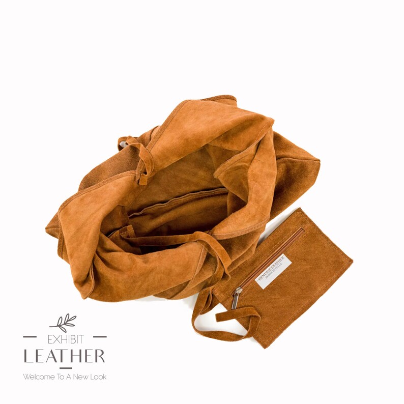 May include: A brown suede tote bag with a zippered pouch. The bag has a drawstring closure and is made of soft, supple leather. The pouch has a zipper closure and is made of the same material as the bag.