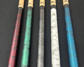 May include: Five pool cues with varying colors. The cues have light-colored wooden shafts and colorful, patterned handles in red, green, gray, white, and blue. Each cue has a black band near the top and a logo.