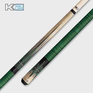 May include: A pool cue with a green and black patterned handle and a light-coloured shaft. The cue features a decorative design with black and green diamond shapes. The K2 logo is visible on the cue.