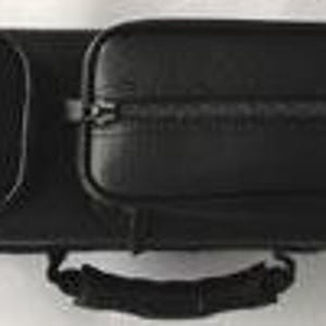 May include: A black leather pool cue case with a handle and two zipped compartments. The case has a silver clasp on the end and a small pocket. The case is designed to hold pool cues and accessories.