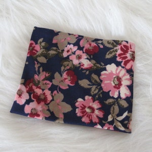May include: A navy blue fabric with a pink and brown floral pattern.