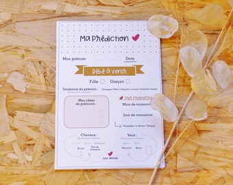 May include: A white card with the title "Ma Prédiction" and a pink heart. The card is a baby shower prediction game with sections for the baby's gender, name, birth month, and physical characteristics.