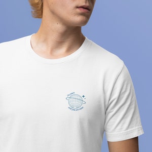 May include: White t-shirt with a blue graphic of a globe with a ring around it and stars. The text "I'm yours and you are mine" is written on the graphic.