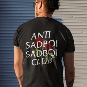 May include: Black t-shirt with white text that reads "ANTI SADBOI SADBOI CLUB" and a red rose graphic.