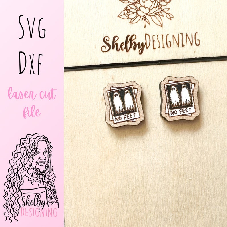 May include: A pair of wooden earrings with a laser-cut design of two ghosts in a photo frame. The frame has the text "No Feet" printed on it.