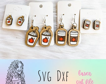 May include: Three sets of laser cut wooden earrings featuring fall-themed designs. The first set features a pumpkin spice latte with whipped cream, the second set features a pumpkin spice latte with whipped cream, and the third set features a coffee cup with a pumpkin on it. The earrings are on white card stock.