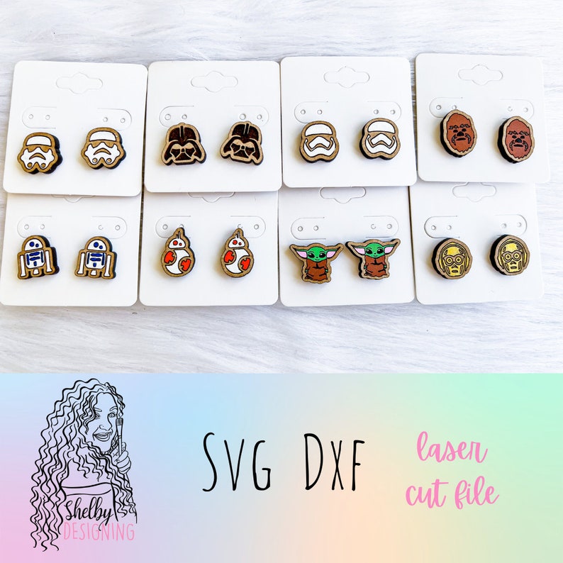 May include: A set of 10 pairs of laser cut wooden earrings featuring characters from Star Wars. The earrings are displayed on white card stock.