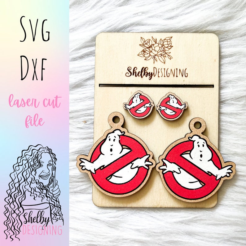 May include: A set of laser cut wooden earrings featuring a red no ghost symbol with a white ghost inside. The earrings are available in two sizes, with the larger pair being suitable for dangle earrings.
