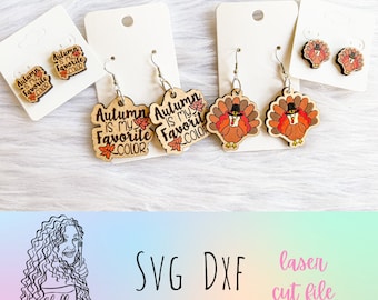 May include: A set of laser cut wooden earrings featuring a Thanksgiving theme. The earrings are shaped like turkeys and have the text "Autumn is my favorite color" on them.