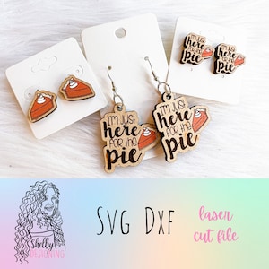 May include: A set of laser cut wooden earrings featuring a pie design. One pair says "I'm just here for the pie" and the other pair features a slice of pie with whipped cream.
