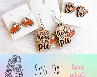 May include: A set of laser cut wooden earrings featuring a pie design. One pair says "I'm just here for the pie" and the other pair features a slice of pie with whipped cream.