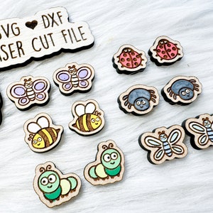 May include: Wooden laser cut files featuring various insects, including butterflies, bees, ladybugs, spiders, and caterpillars. The designs are hand-painted with bright colors and outlined with a dark brown burn. The text "SVG DXF LASER CUT FILE" is also visible.