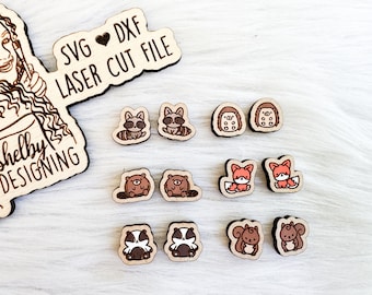 May include: A set of 10 laser cut wooden animal earrings. The earrings feature a raccoon, beaver, hedgehog, fox, and squirrel. The earrings are all in shades of brown, orange, and black.