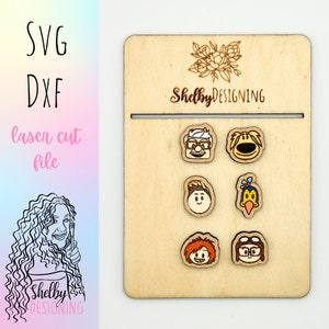 May include: Wooden laser cut file featuring character designs. The file includes the text "SVG", "DXF", and "laser cut file". The wooden display board has the text "Shelby DESIGNING" and a floral design.