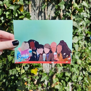 May include: A postcard featuring a group of people, each holding a milkshake or drink. The illustration has a teal background and a red border at the bottom. The people are depicted in various outfits and hairstyles.