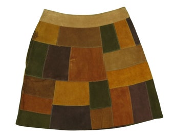 May include: A brown suede mini skirt with a patchwork design featuring various shades of brown, green, and tan.