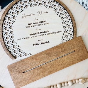Semi circle shape bar menu standing sign made using layered Baltic birch plywood. Laser cut can rattan pattern border around the perimeter. Raised solid wood border in stained color of choice. Center area can be laser engraved with customized text.