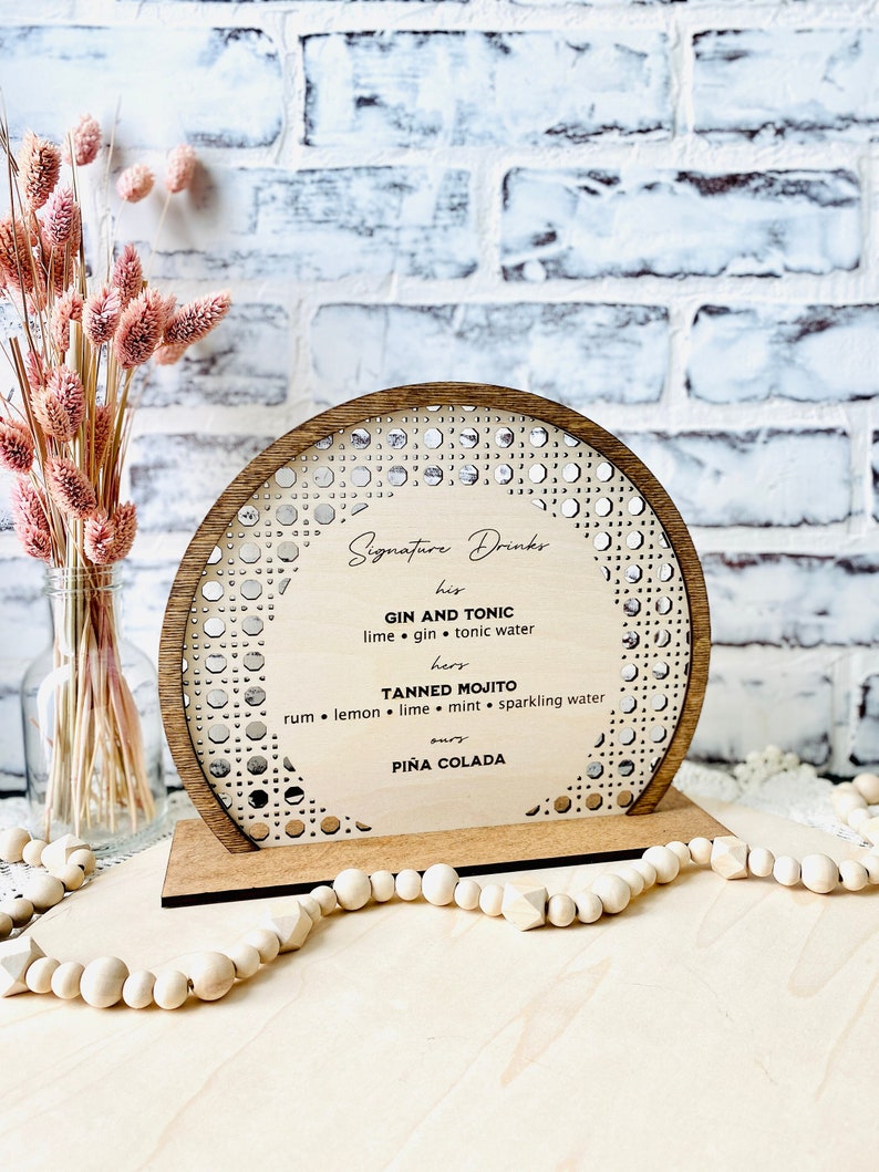 Semi circle shape bar menu standing sign made using layered Baltic birch plywood. Laser cut can rattan pattern border around the perimeter. Raised solid wood border in stained color of choice. Center area can be laser engraved with customized text.