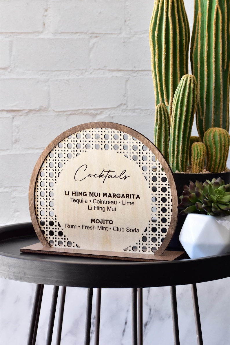 Semi circle shape bar menu standing sign made using layered Baltic birch plywood. Laser cut can rattan pattern border around the perimeter. Raised solid wood border in stained color of choice. Center area can be laser engraved with customized text.