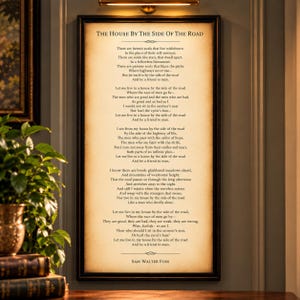 May include: A rectangular framed wall art piece featuring the poem The House by the Side of the Road by Sam Walter Foss printed in black text on a parchment-colored background. The frame is dark brown with a simple, clean-lined design.