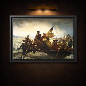 May include: Framed print of the iconic painting "Washington Crossing the Delaware" by Emanuel Leutze. The artwork depicts George Washington and his troops in a boat, navigating icy waters. The print is in a black frame and is illuminated by a gold-toned light fixture.