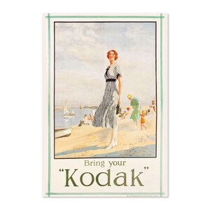 May include: A vintage Kodak advertisement featuring a woman in a striped dress standing on a beach with other people and boats in the background. The text reads "Bring your "Kodak""