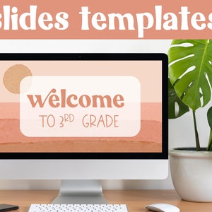 May include: A computer screen displaying a welcome slide for third grade. The slide has a peach background with a white rectangle in the center. The rectangle contains the text "welcome to 3rd grade" in a brown font. The screen is on a desk with a plant and a keyboard.