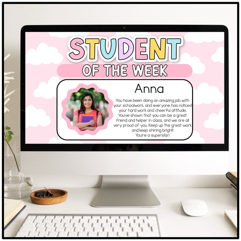 May include: A pink and white computer screen with the text "STUDENT OF THE WEEK" in rainbow colors. A photo of a young woman with brown hair and a pink shirt is in the center of the screen. The text below the photo reads "Anna You have been doing an amazing job with your schoolwork, and everyone has noticed your hard work and cheerful attitude. You've shown that you can be a great friend and helper in class, and we are all very proud of you. Keep up the great work and keep shining bright! You're a superstar!"