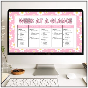 May include: A pink and white computer screen with a weekly schedule titled "Week at a Glance". The schedule is divided into five columns: Monday, Tuesday, Wednesday, Thursday, and Friday. Each column lists literacy and numeracy activities for each day.