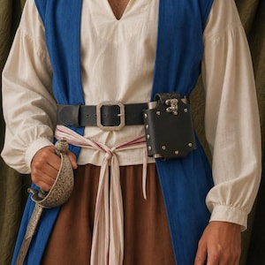 May include: A cream-coloured long-sleeved shirt worn under a sleeveless blue vest, paired with brown trousers. A black leather belt with a silver buckle holds a black leather pouch and a silver-toned sword with an ornate, engraved hilt.